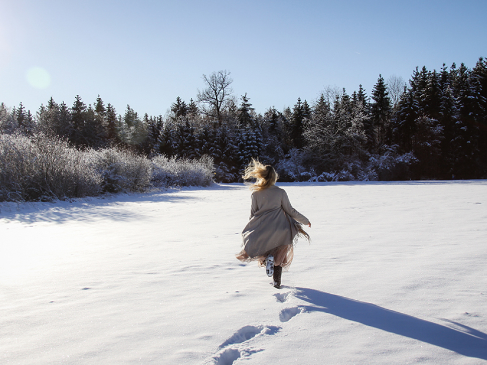 blonde girl playing in the snow