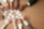 Hands of multi-ethnic team assembling jigsaw puzzle, multiracial group of black and white people joining pieces at desk, successful teamwork concept, help and support in business, close up top view