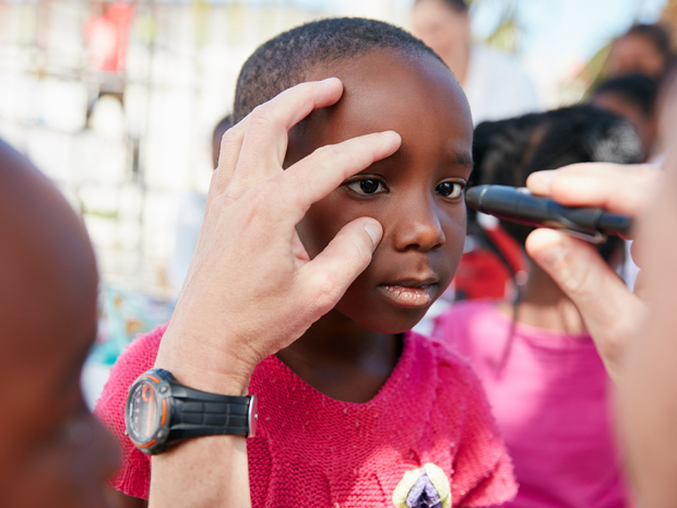 Shot of a volunteer doctor giving checkups to underprivileged kids