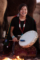 Navajo girl playing a traditional drum around a campfire in Monument Valley Arizona